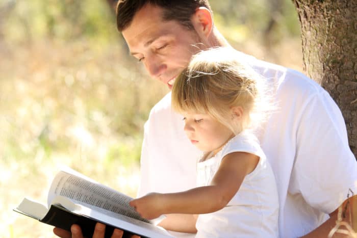 dad and child with bible