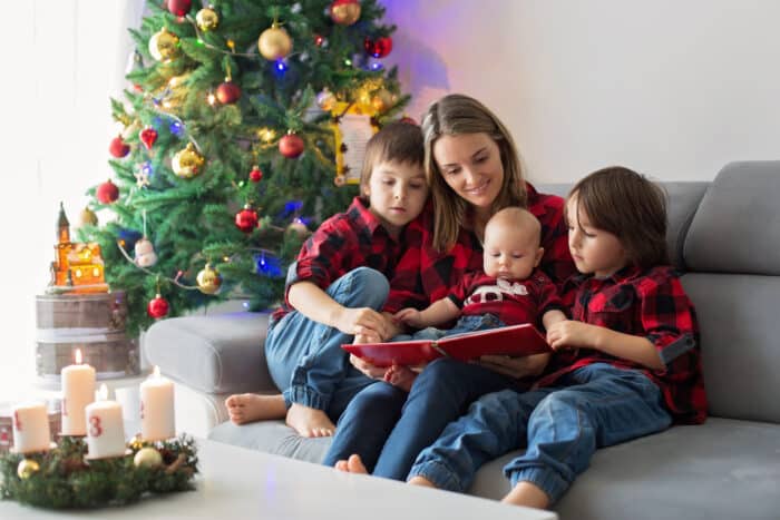 mom and 3 kids reading best Christmas picture books