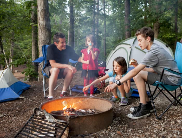 family camping around campfire
